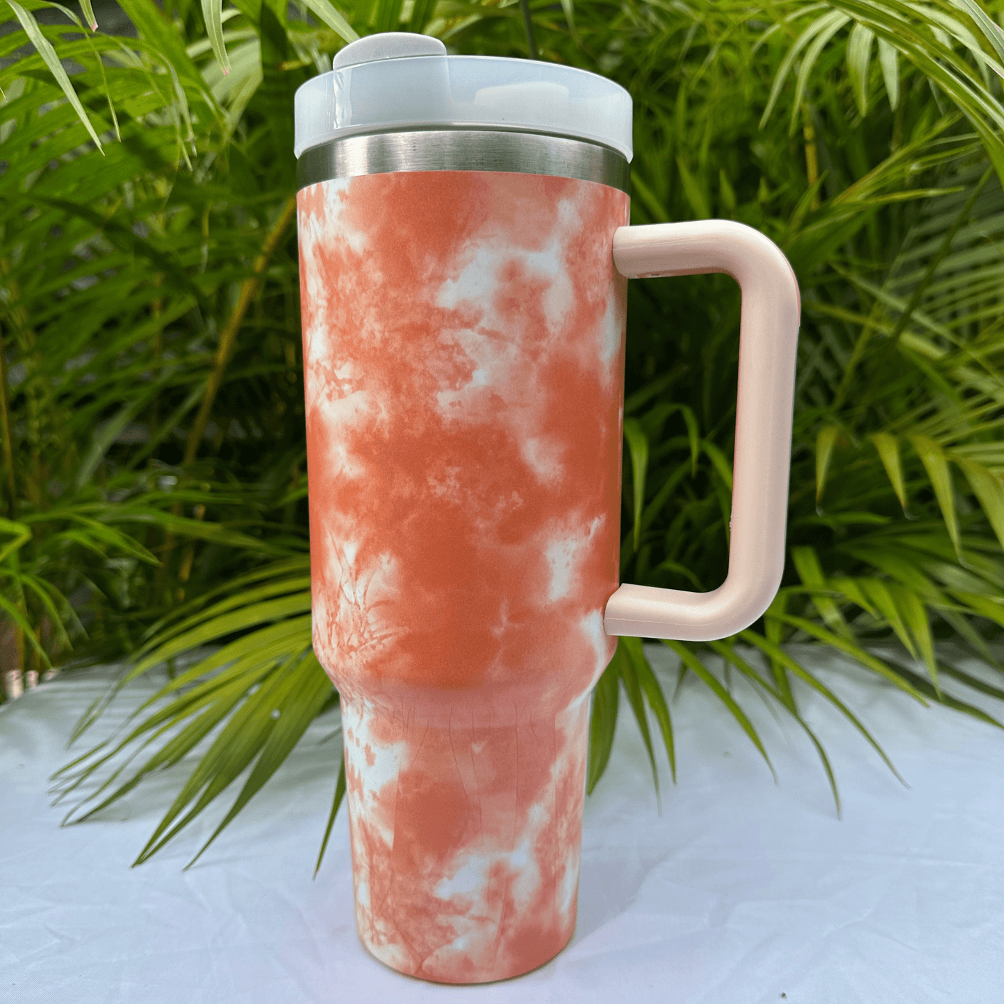 Orange tie-dye flask with a unique, vibrant pattern, perfect for carrying beverages in style, featuring a secure screw cap and durable construction.