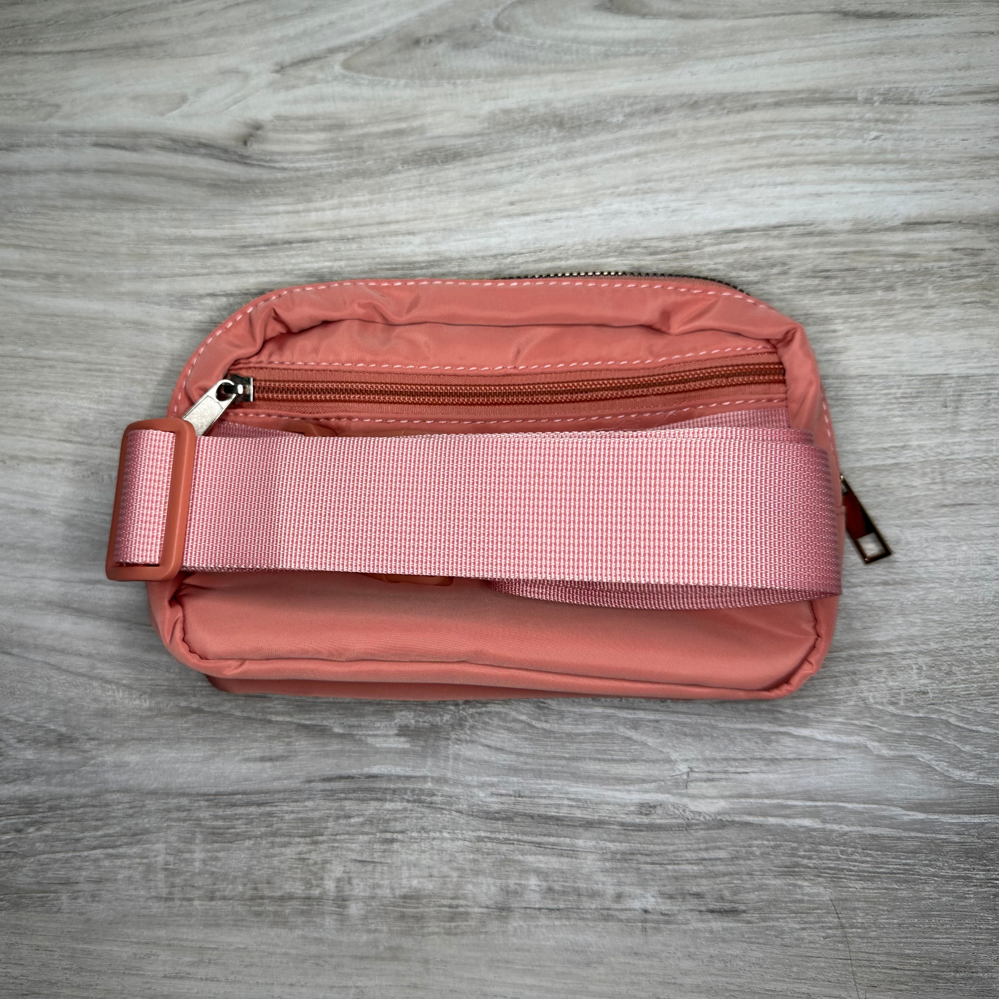 Single pouch bag with a compact design and spacious interior, perfect for carrying essentials, featuring durable material, stylish look, and a convenient adjustable strap.