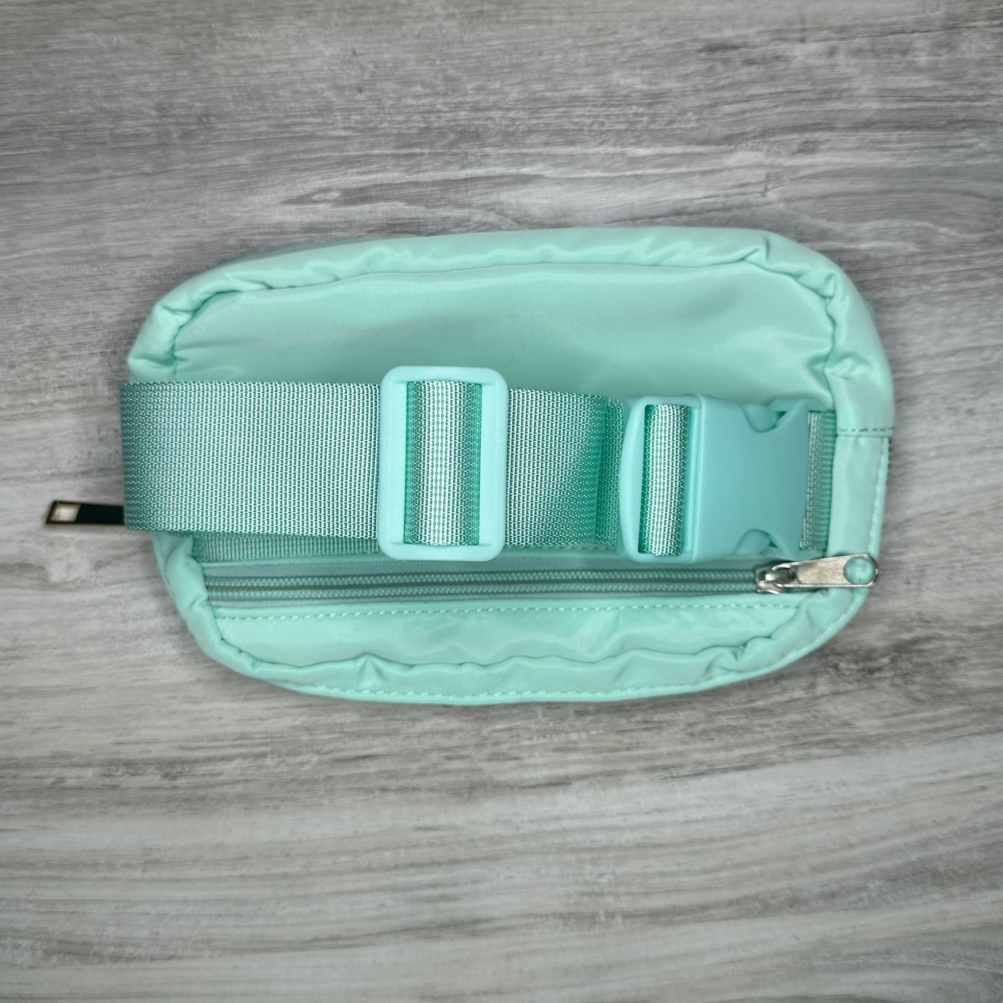 Single pouch bag with a compact design and spacious interior, perfect for carrying essentials, featuring durable material, stylish look, and a convenient adjustable strap.