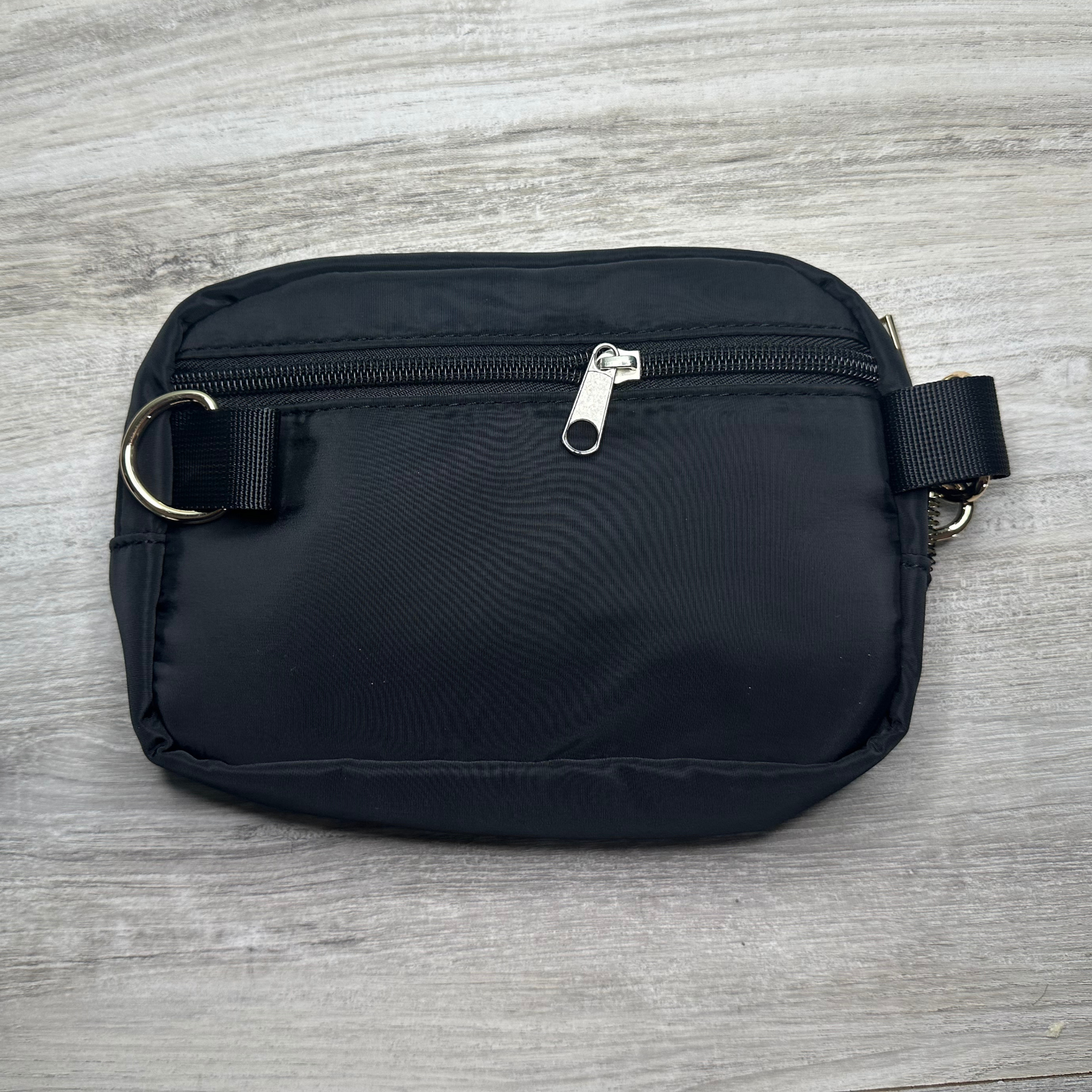 Single pouch bag with a compact design and spacious interior, perfect for carrying essentials, featuring durable material, stylish look, and a convenient adjustable strap.